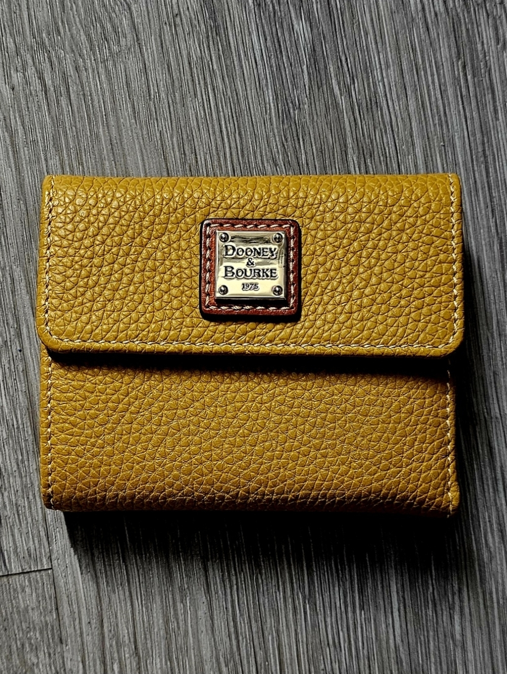 Dooney & Bourke Mustard Pebble Leather Fold Wallet with Brass Plaque